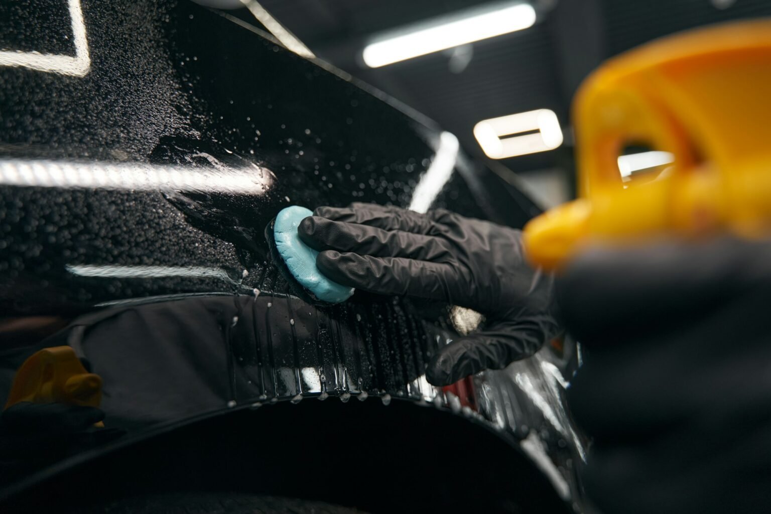 Professional preparing vehicle for paint protection