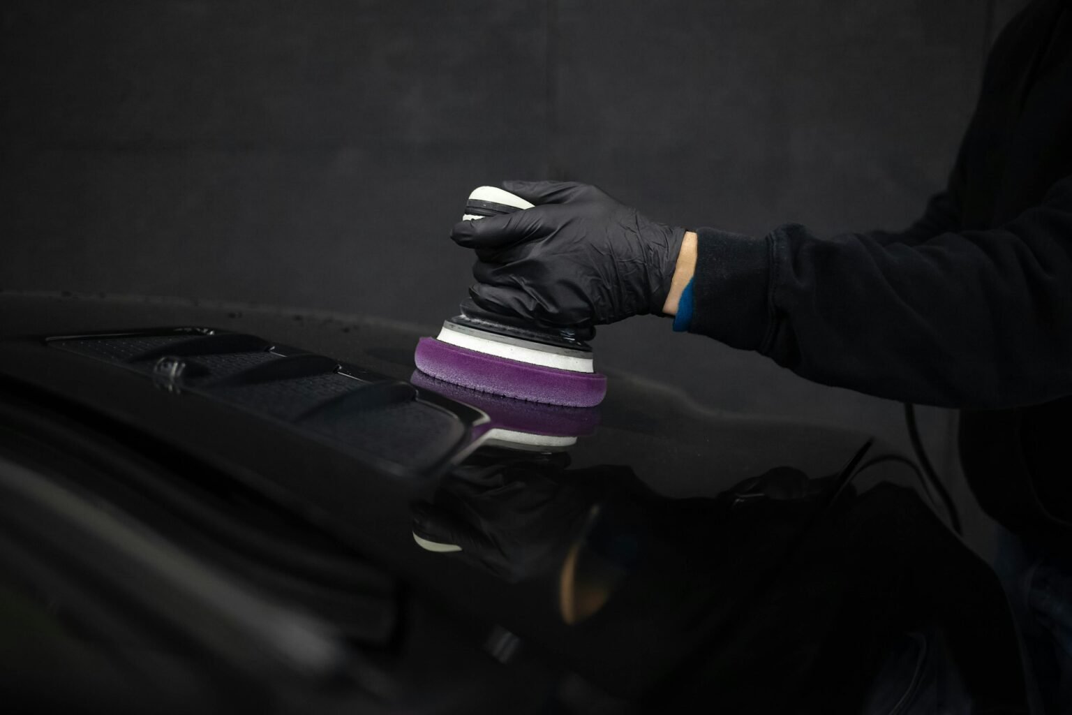 Detailing specialist polishing a car